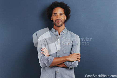 Image of Happy man, portrait and arms crossed in studio as professional, confident and fashion by blue background. African person, face and smile for ambition as designer and creativity or pride in mock up