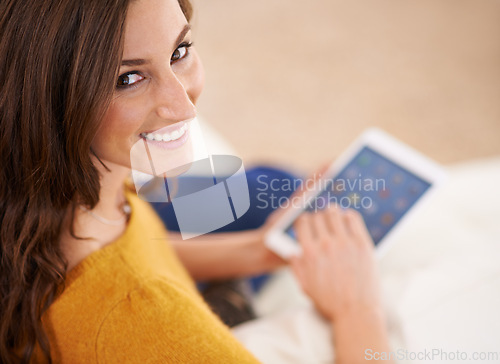 Image of Happy, portrait and woman with tablet on sofa reading ebook on app to relax on holiday or vacation in home. Girl, smile and lounge on tech with blog, article or news from search on internet in house