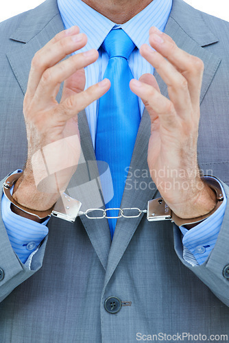 Image of Businessman, hands and cuffs with strain for theft, crime or corruption on a white studio background. Closeup of man or employee tied up with chain for arrest, criminal or illegal bribery of the law