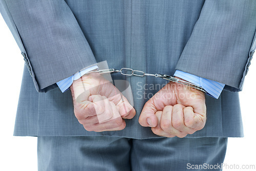 Image of Businessman, hands and cuffs with crime for theft or corruption on a white studio background. Closeup of man or employee back tied up with chain for arrest, criminal or illegal bribery of the law