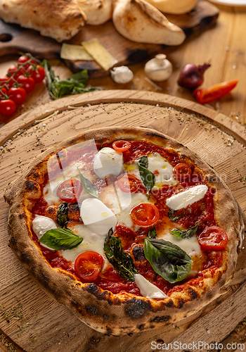 Image of Pizza topped with fresh tomatoes and mozzarella