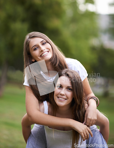 Image of Girl friends, smile and portrait with piggyback in park with bonding and fun on campus outdoor. Students, grass and happy together in a university garden on a break for summer holiday in nature