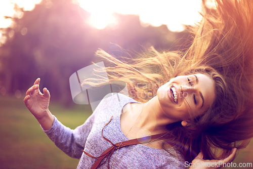 Image of Smile, dance and hair in nature for happy woman person, freedom and excited in park. Confidence, dancer and summer sunshine or sunset with lens flare, joy and fun from good news or achievement