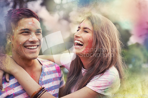 Image of Happy, powder paint and couple of friends laugh outdoor with Holi festival and colorful event with smile. Celebration, hug and excited in nature with hipster people and crazy fun dust for party