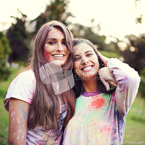 Image of Color, festival and portrait of women with powder together for fun, Holi and outdoor social in spring, nature and joy. Smile, paint splash and celebration in park with friends, trees and happy event