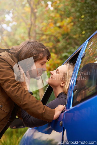 Image of Travel, window and couple kiss in car for greeting, goodbye and love on journey, leaving and commute. Transport, driving and man and woman in vehicle for bonding, relationship or embrace on road trip