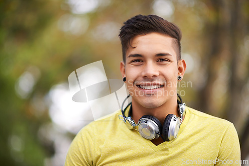 Image of Smile, portrait and young man in nature by outdoor park, field or garden for fresh air. Happy, gen z and face of cool male person from Mexico with positive, good and confident attitude for style.