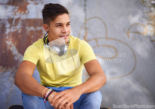 Image of Smile, thinking and young man at skatepark for skating practice or training for competition. Happy, gen z and face of cool male person sitting on ramp with positive, good and confident attitude.