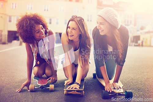 Image of Skatepark, laugh and friends in street for balance, hobby or competition in city. Skater, lens flare and diverse group of women with skateboard for training, exercise or happiness in outdoor activity