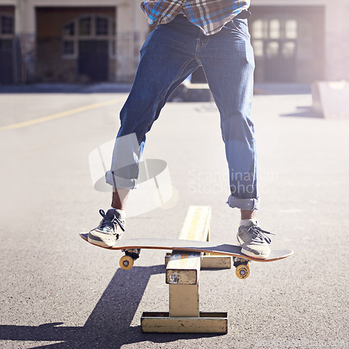 Image of Skatepark, balance and man with riding skateboard for technique, skill and trick in recreation activity. Skateboarder, lens flare and male person for training, competition or hobby in city of Atlanta