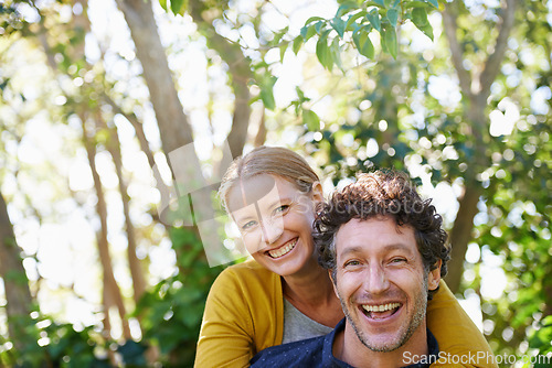 Image of Happy, couple and piggyback outdoor in portrait for love and bonding, trust and support in commitment for marriage. Partner, loyalty and fun with people in nature for fresh air on date for romance