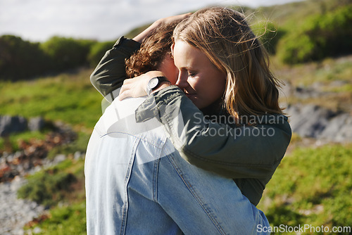 Image of Hug, nature and couple with love, smile and happiness with weekend break and holiday for honeymoon. Outdoor, romance and embrace with woman and man with sunshine and summer with vacation or adventure