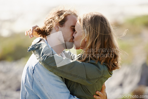 Image of Caring, couple and kissing or hug on mountain, nature and scenery with passionate people in relationship. Love, care and embrace on romantic date, vacation or holiday in Sweden together in summer