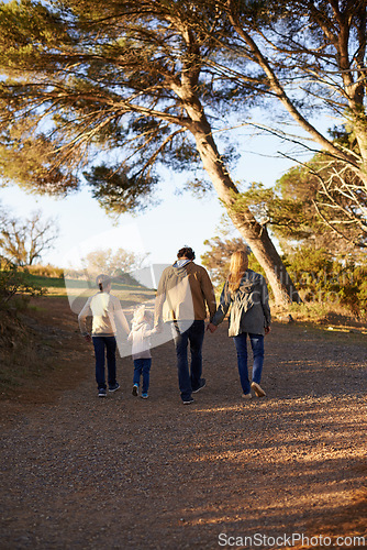 Image of Family, nature and walk for exercise, fitness and bonding for parents and children. Sunset, autumn and forest for hike on holiday in English countryside, mother and father for outdoor activity