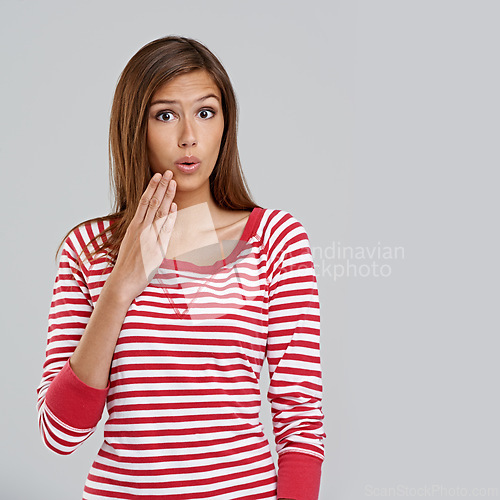 Image of Hand, shock and portrait of woman with surprise for omg, wow or mockup isolated on gray background. Model, casual or lady for fashion, style and trendy with stripe shirt, top or outfit and expression