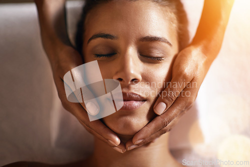 Image of Woman, spa and face massage on towel with hands and care for facial, wellness and beauty treatment on bed. Above, lens flare and african female person with skincare and relax at hotel with skin glow