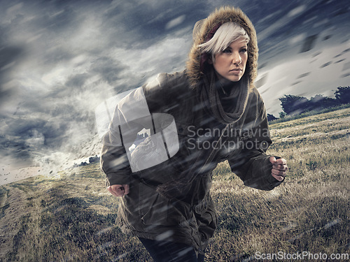 Image of Woman, forest and running in storm weather, nature and survival or safety for climate change. Athlete, warm jacket or strong in woods with rain, environment or runner for global warming as warning