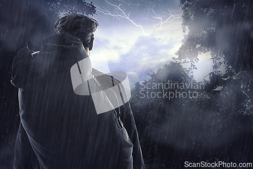 Image of Man, forest and camping with survival in storm, thunder and shelter of lightning in outdoor environment. Camper, backpack and view in nature with rain, back and hiking in dangerous weather conditions