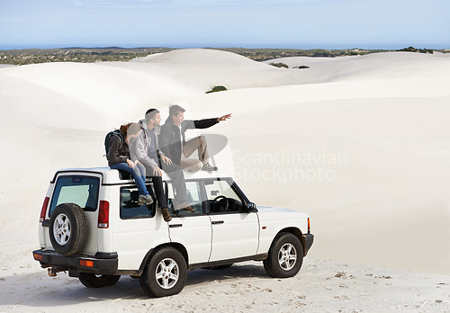 Image of Friends, people on car in desert and travel for tourism in Dubai for safari, road trip and view. Adventure, journey and transportation with offroad vehicle or 4x4 on vacation for break outdoor