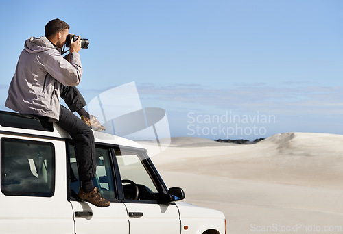 Image of Road Trip, dunes and man in nature for photography, desert landscape and travel for holiday. Pictures, 4x4 and nomad male person in Sahara terrain, outdoor and transport in dry climate and scenery