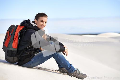 Image of Portrait, sand dunes or woman in nature to relax for adventure, desert landscape and travel for holiday. Break, hiking or nomad explorer in Sahara terrain, outdoor and dry climate for view or scenery