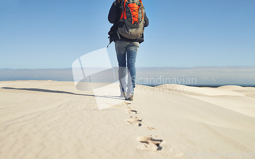 Image of Walking, sand dunes or legs of person for adventure, desert landscape and travel for holiday vacation trip. Back view, hiker and nomad explorer hiking in Sahara terrain, outdoor and dry climate