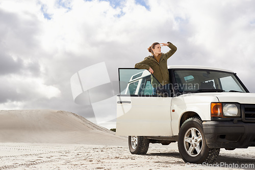 Image of Road trip, car and woman in a desert for location, search or holiday, adventure and exploration. Travel, stop and female person with vehicle in Egypt for sand dunes journey, nature or waiting outdoor