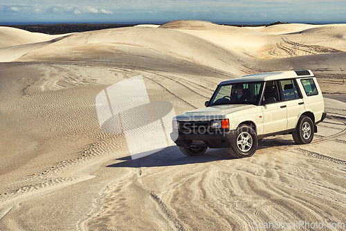 Image of Car, desert and driving with travel and transportation outdoor, off road vehicle for sand dunes and journey on vacation. Van, 4x4 or SUV with adventure, explore destination and tourism in Dubai