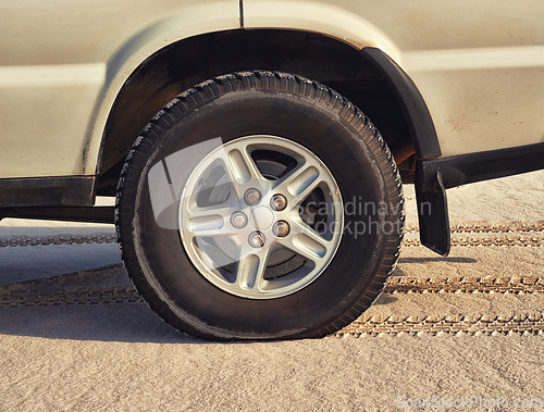 Image of Tyre, car in desert and travel with transport outdoor, off road vehicle for sand dunes and journey on vacation. Wheel, 4x4 and SUV with adventure, exploration and destination for tourism in Dubai