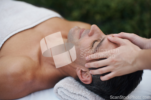 Image of Spa, man and face with massage for wellness at resort, luxury hotel and vacation for relax and therapeutic pamper. People, masseuse and body care with facial treatment, hospitality and hands outdoor