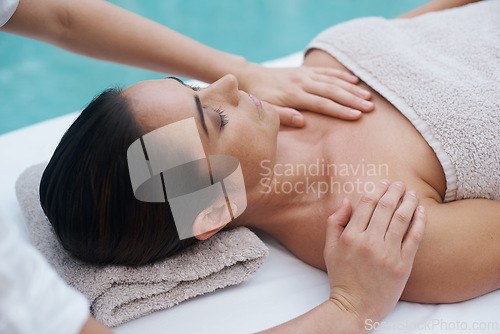 Image of Hands, woman and luxury at spa for massage, skin care and wellness for health, therapy and peace. Female person, lady and relax for zen, body and tranquil on table, calm and wellbeing near pool