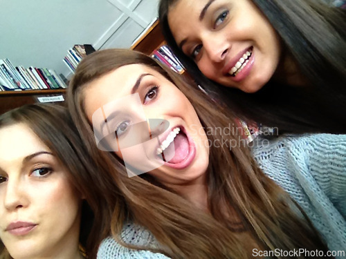 Image of Women, university student and happy with selfie as friends in library for study break or group work for exams. Classmates, college and campus on leisure with smile for test or assignment and pov