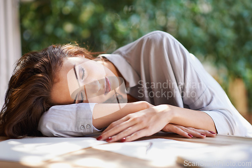 Image of Tired, student and woman outdoor studying on table with notes in garden at university. Girl, relax and sleeping with writing, project or notebook on desk and rest from fatigue and burnout at college