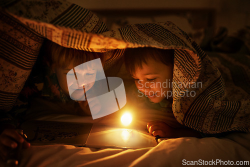 Image of Blanket, flashlight and children at night with happiness reading a book with fantasy and magic. Friends, relax and storytelling in dark with light under duvet at sleepover with a pillow tent