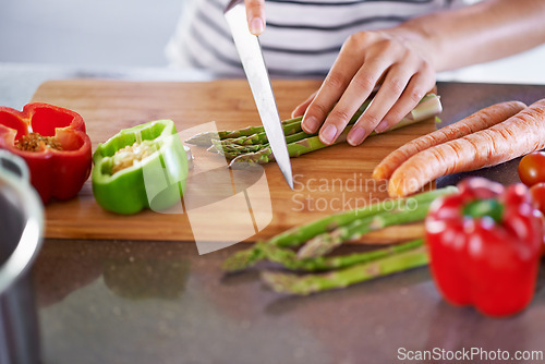 Image of Chopping, healthy and cooking in home kitchen, organic food or meal prep with fresh produce. Diet, nutrition and cutting board for wellness ingredient, pepper asparagus or carrot in vegan lunch snack