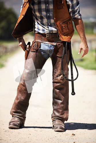 Image of Person, outdoors and gun ready to shoot for standoff or gunfight in duel for wild western culture in Texas. Cowboy gunslinger or outlaw, revolver and confrontation for defense or conflict with battle