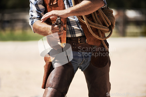 Image of Cowboy, confrontation and aim gun to shoot for standoff or gunfight in duel for wild western culture in Texas. Male gunslinger or outlaw, revolver and tough for defense or conflict with closeup