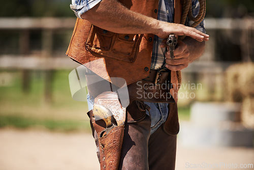 Image of Cowboy, tough and aim gun to shoot for standoff or gunfight in duel for wild western culture in Texas. Male gunslinger or outlaw, revolver and confrontation for defense or conflict with closeup