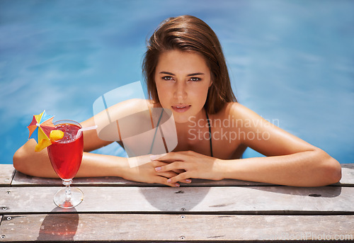 Image of Woman, portrait and relax with cocktail in swimming pool with bikini for leisure, luxury and resort or villa. Girl, summer and tropical vacation or holiday in Maldives with beverage for sunbathing.