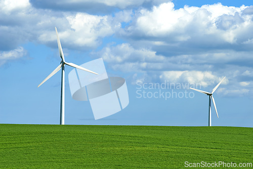 Image of Wind turbine, grass and sky with clouds for nature in environment and outdoor for landscape and energy. Sustainability, weather and season with ecology for farm and field in agriculture and industry