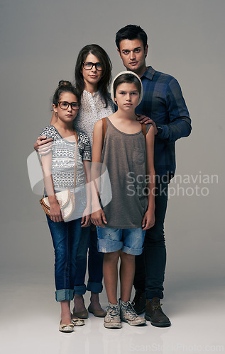 Image of Parents, kids and together in studio portrait with pride, care and support with love by background. Mother, father and children in group for family, kindness and clothes with trendy fashion for style