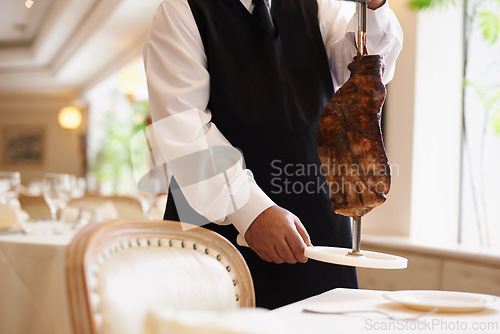 Image of Waiter, fine dining and beef with service, skewer and restaurant for dinner or lunch. Person, food and luxury with gourmet, meal and expensive cuisine with meat or protein on stake at elegant diner