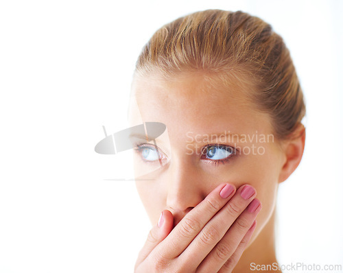 Image of Face, woman and studio in shock with embarrassed in white background and thinking with idea. Hand, amused and surprised with secret for gossip, story and amazed with thoughts and shy with news