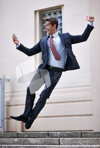 Image of Business, jump and excited man with phone in city street celebration for wow, news or winner fist gesture. Smartphone, energy or male entrepreneur with app alert for online competition prize or lotto