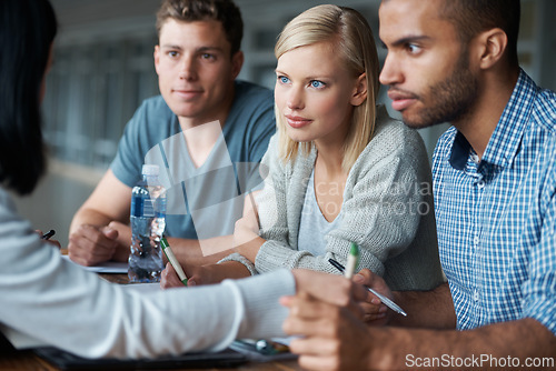 Image of Education, college and students in studying together for learning, share ideas and research for project. Paper, writing and academic discussion for assignment on campus, diversity and scholarship