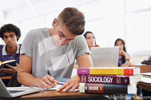 Image of Student, man and writing with textbooks, education and university with exams and research for test. Person, college and guy with ideas or laptop with inspiration or studying with learning or deadline