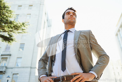 Image of Professional man, city and buildings with pose for thinking, ideas or vision in Los Angeles. Business person, entrepreneur and confidence outdoors for opportunity, mindset and ambition from low angle
