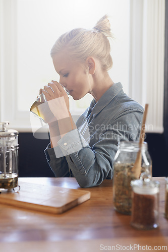 Image of Woman, brewing and home with herbal tea in kitchen with plunger, jug and ingredients for healthy and warm beverage. Home herbs, morning and fresh to taste, drink and enjoy before day at work.