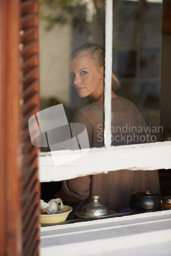 Image of Portrait, woman and smile by window for relax with reflection, weekend break and calm expression in home. Person, face and happy with confidence, pride and casual clothes in apartment in winter