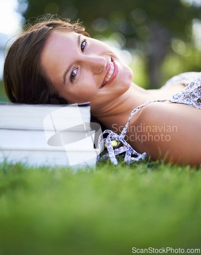 Image of Books, park and portrait of woman relax, happy and resting for studying, reading and learning. Education, university and person outdoors for wellness, fresh air and peace with textbooks for knowledge